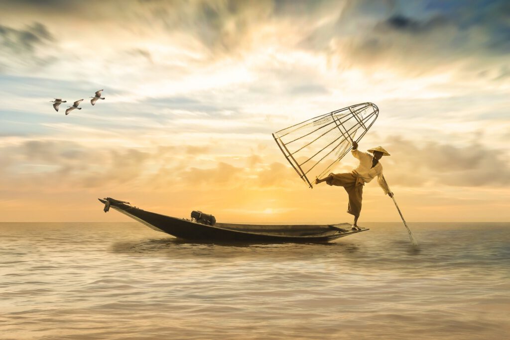 Fisherman standing on a small boat