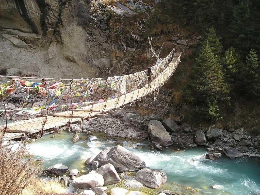 Photo: Primitive suspension bridge over river